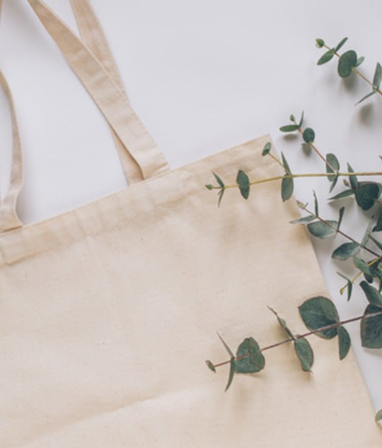 Close-up of PackQueen calico tote bag laid down