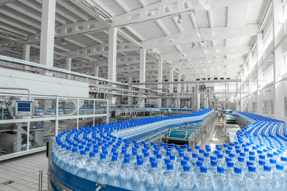 Plastic bottles on a conveyor belt in a factory